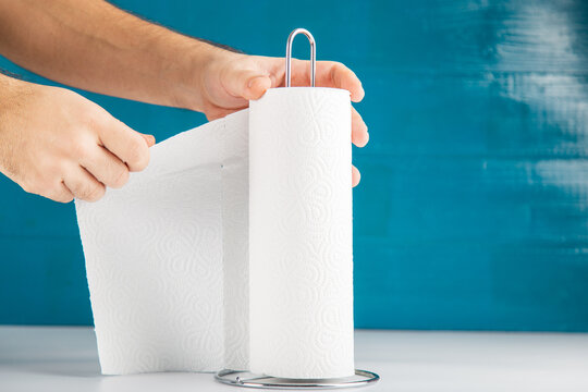 An Anonymous Hand Is Tearing Off Paper Towel, Hygiene Concept Copy Space Includes.