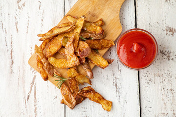 Fried potato peel on a white wooden table. Top view. Sustainable food.