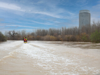two rescuers navigate the river with the jet ski