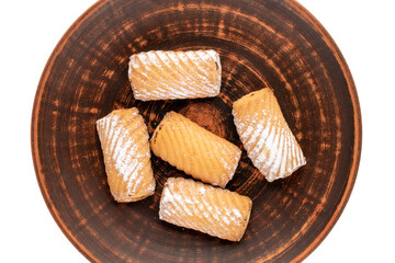 Several homemade cookies stuffed with jam on a clay platter, close-up, top view.