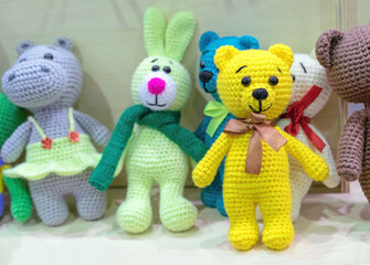 Knitted yellow bear with a bow. Knitted toys in stock.
