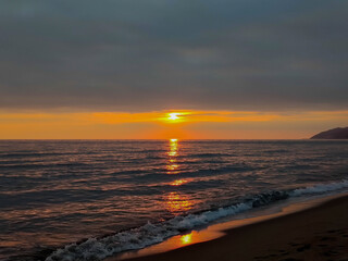 Fototapeta premium evening november sky with sunset over mediterranean sea/beach at autumn 