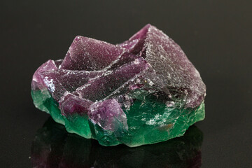 Fototapeta premium macro mineral stone green and purple fluorite on a black background