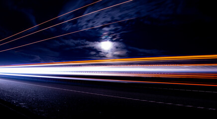 lights of cars with night. long exposure, moon and sky