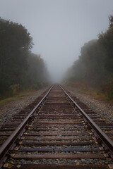 Fototapeta na wymiar Foggy train tracks in the morning.