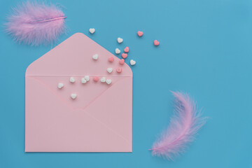 Delicate blue shades. Postcard for Valentine's Day, invitation to wedding, engagement, birthday. Colorful hearts, feathers and an envelope on a blue background.