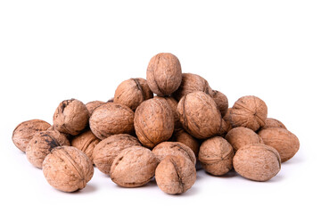 Walnuts stacked in a bunch, photographed close-up on a white background