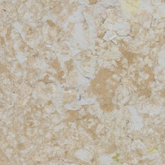 Fototapeta premium Fragment of recycled paper. Texture, background. Paper elements are clearly visible. The concept of an environmentally friendly attitude to the environment. View from above.