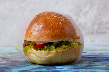 Homemade burger with paper. Minimalism