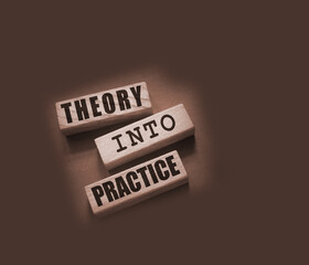 Theory into practice words written on wooden blocks. Education or business startup concept