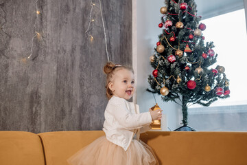 little girl with a christmas tree