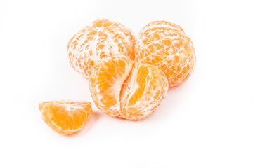 white background. several peeled tangerines. the slice lies ahead. close-up.