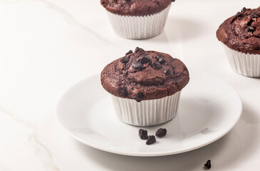 Chocolate muffins on the marble surface. - 476912142