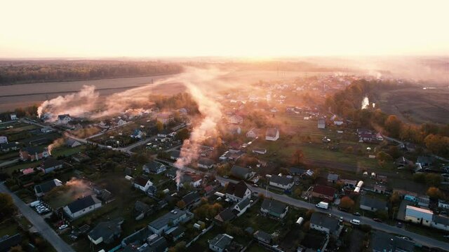 Country houses in the countryside. Aerial view of roofs of green field with rural homes. Village with wooden home. Suburban house at farm. Housing outside the city. Agriculture, farming and agronomy.