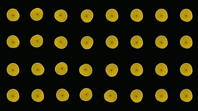 Colorful pattern of dried orange slices on black background. Seamless pattern with dried orange chips. Realistic animation. 4K video motion