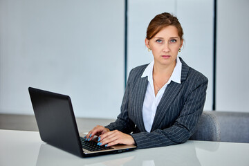Woman makes work at home using laptop.