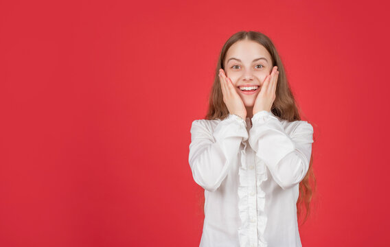 amazed child hold face express positive emotions on red background copy space, flash sales.