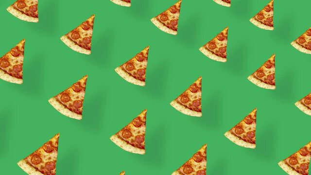 Colorful pattern of pizza isolated on green background with shadows. Seamless pattern with pizza slices. Top view. Realistic animation. 4K video motion