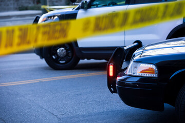 Detail view of illuminated police lights and cordon tape. © Matt Gush