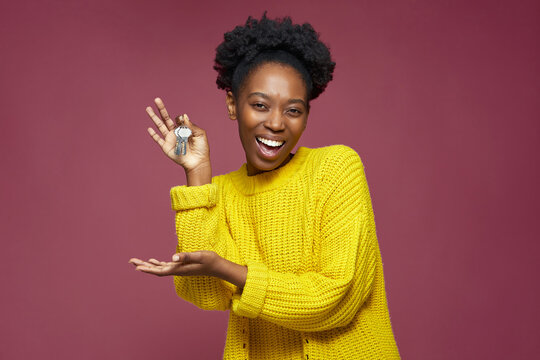 Joyful excited african american woman hold home key in hand buying modern apartment. Black woman win new flat in lottery