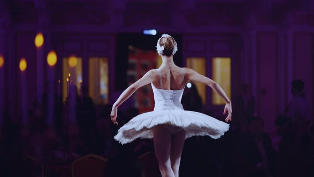 The ballerina performs in the banquet hall of the restaurant in front of the public