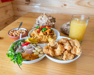 Ceviche with seafood rice and fish chicharron. Peruvian food, seafood trio.