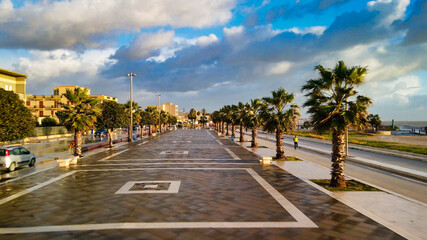 Aerial view of Mazara del Vallo city promenade along the ocean, beautiful coast of Sicily at sunset from drone.