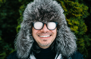 portrait of a person with fogged up eyeglasses and fur hat in winter