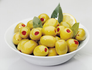 bunch of stuffed green olives on a white background