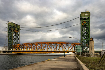 The Hamilton lift bridge over the Burlington Bay Canal between Lake Ontario and Hamilton Harbour with the old Hamilton Main Lighthouse.