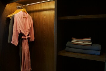 clothes hanger and bathrobe in wardrobe 