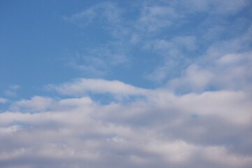 Soft white clouds with colorful light in evening sky