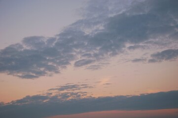 Soft white clouds with colorful light in evening sky