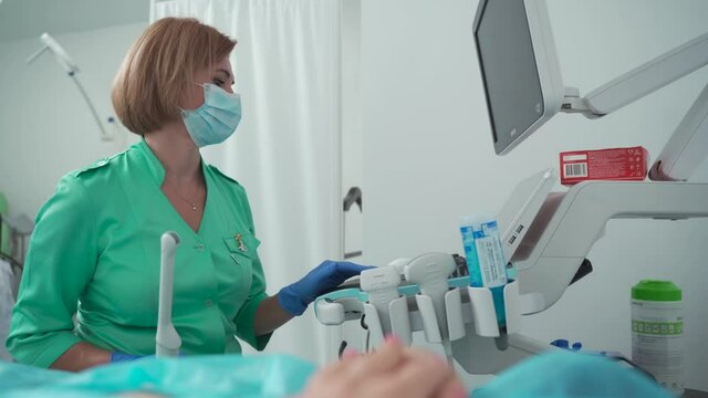 Gynecologist use ultrasound transabdominal and transvaginal wand. Obstetrician office. Female health concept. Diagnostics. Sonography. Ultrasound of pelvic organs. Examination of uterus and ovaries.