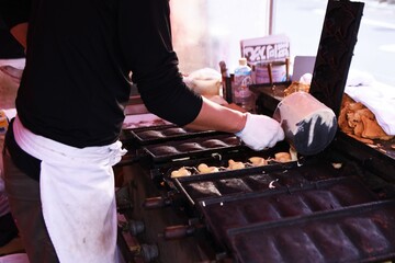 Taiyaki is a fish-shaped pancake filled with red bean paste. It is a popular sweet at Japanese festival stalls. 