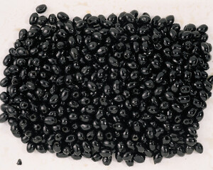 Smoked market fresh black olives as background