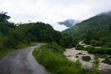 Fototapeta na wymiar Scenery of road and river in rainy monsoon season in mountainous region