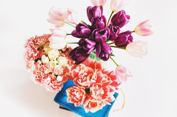 Variety of pink tulip bouquet flowers, top view, spring background
