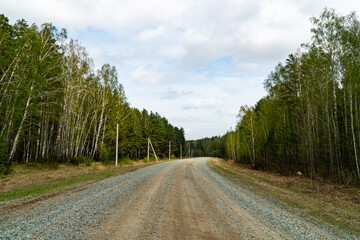 Fototapeta na wymiar Background image of a Siberian highway running through the forest
