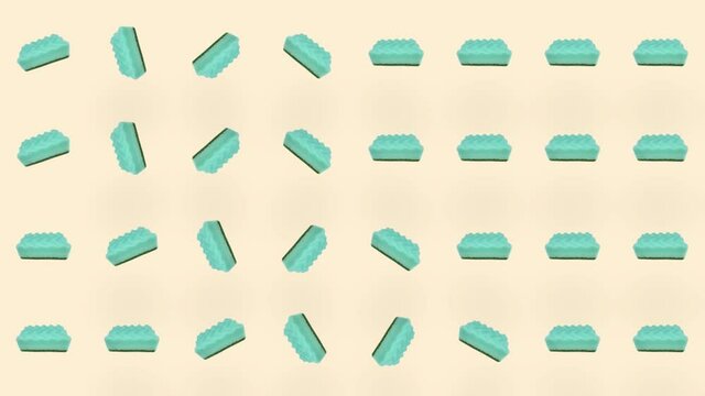 Colorful pattern of green kitchen sponges. Seamless pattern with sponge. Top view. Realistic animation. 4K video motion