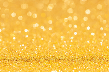 sparkles of yellow glitter abstract background. Copy space