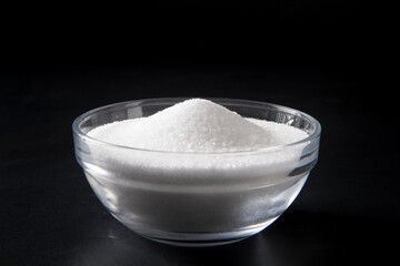 Fototapeta na wymiar salt in a bowl on black background