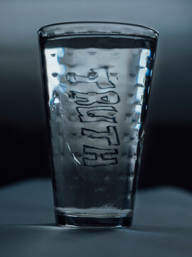 Handwritten Truth distorted in a backlit glass of water