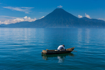 Lonely boat on the lake Atitlan in Guatemala with volcano in the background
