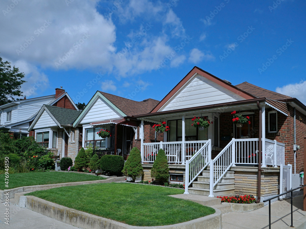 Poster residential street with small detached brick houses with gables