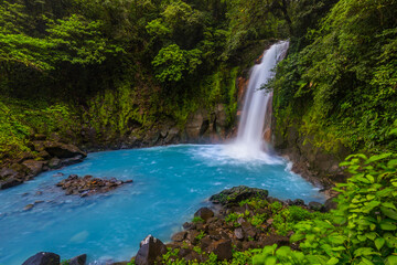Naklejka na ściany i meble Waterfall and natural pool with turquoise water of Rio Celeste, Costa Rica