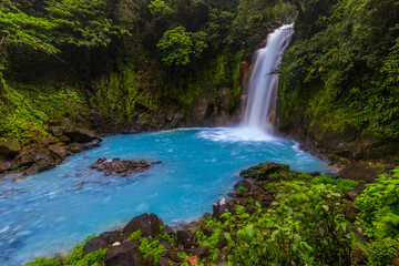 Fototapeta na wymiar Waterfall and natural pool with turquoise water of Rio Celeste, Costa Rica