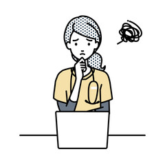 デスクで座ってPCを開いて困っている看護師の女性