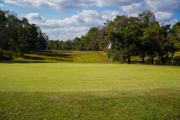 Fototapeta na wymiar Golf course with a rich green turf beautiful scenery.