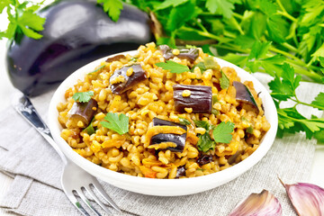 Bulgur with eggplant in bowl on white board